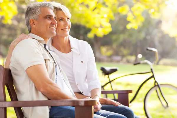 Elegant mid age couple daydreaming retirement outdoors — Stock Photo, Image