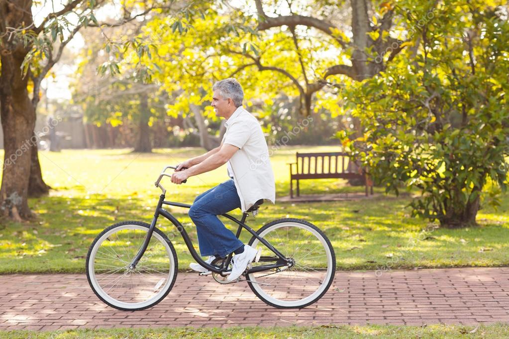 Mid age man riding bicycle — Stock Photo © michaeljung 29905387