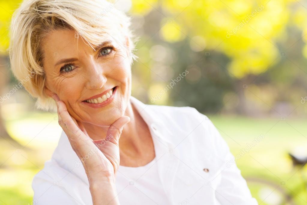 lovely middle aged woman sitting at the park