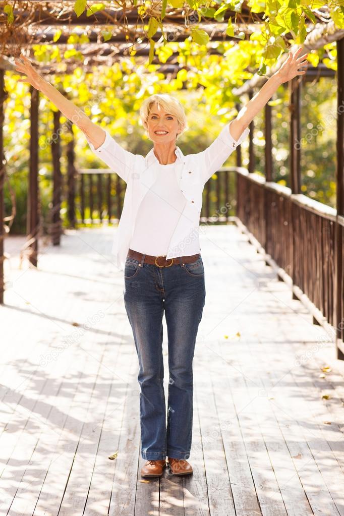 mid age woman with arms outstretched