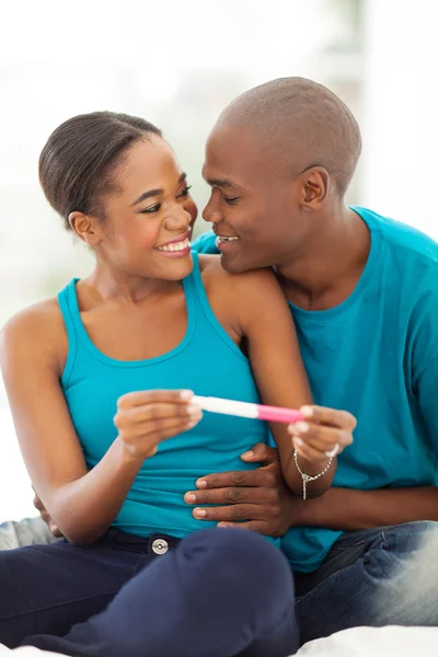 Happy african couple with pregnancy test — Stock Photo, Image