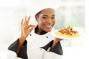 Young african chef with delicious pasta