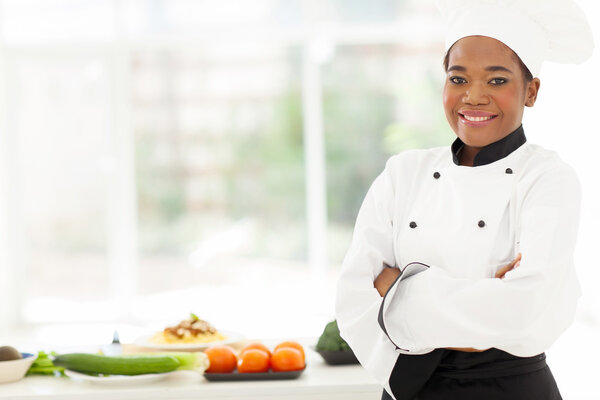 african american female chef with arms folded
