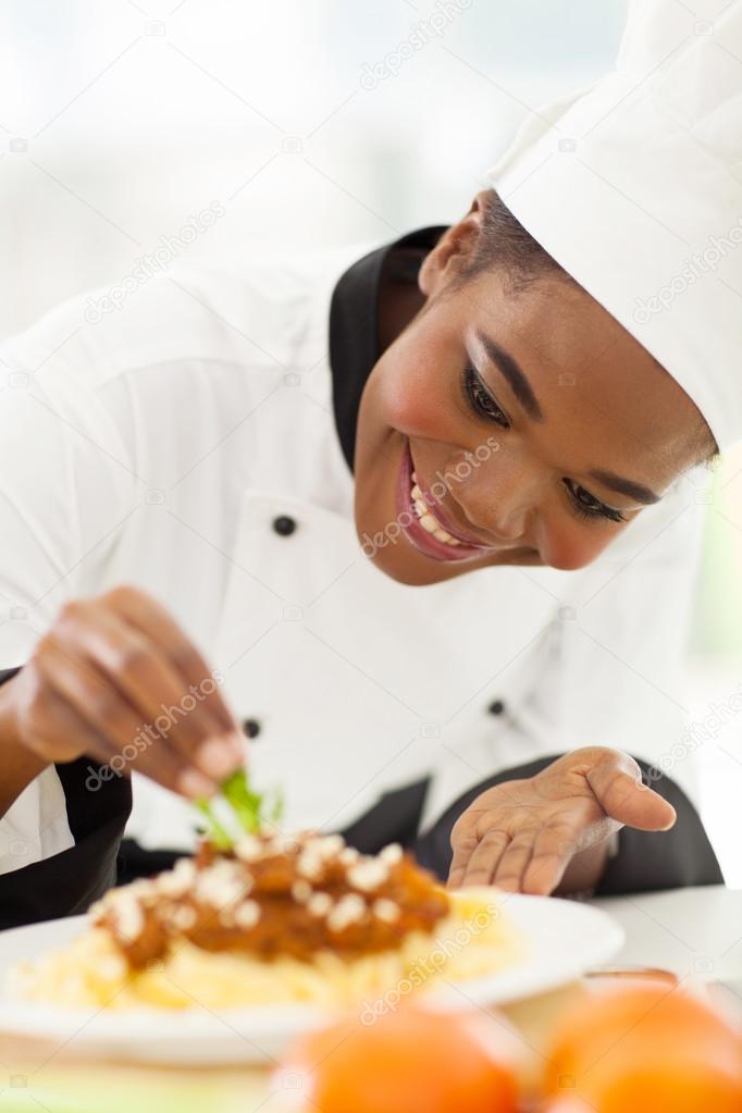 African american chef decorating pasta dish Stock Photo by ©michaeljung