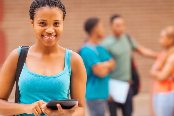 Pretty african college student using tablet computer — Stock Photo, Image