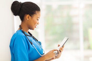 young african american medical worker using tablet computer clipart