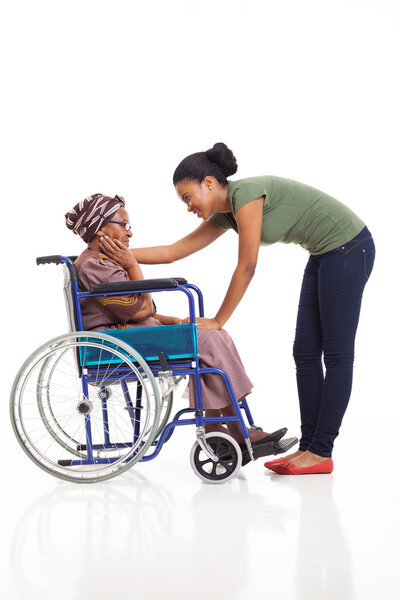 african woman comforting disabled senior grandmother