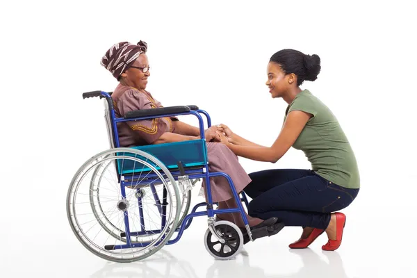 African daughter talking to disabled senior mother — Stock Photo, Image