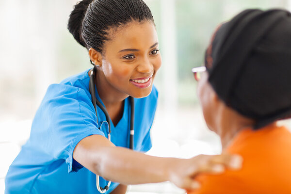 african medical nurse comforting senior patient