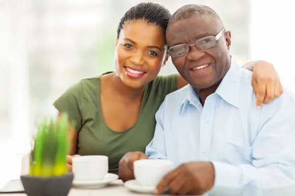 Young adult african girl and father having coffee — Stock Photo, Image