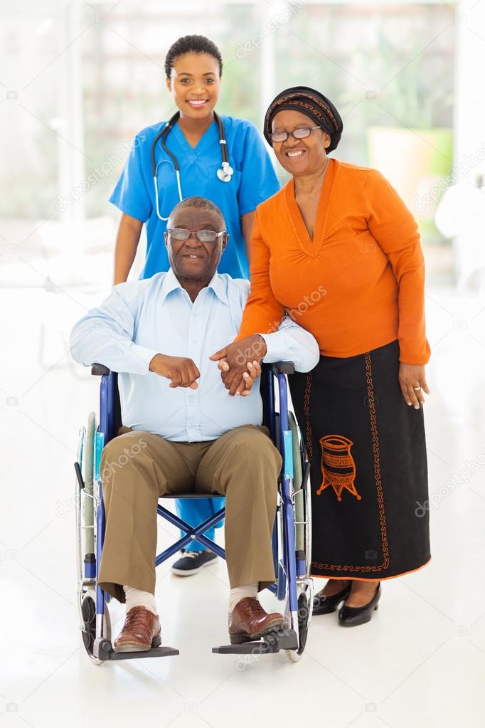 african female healthcare worker with senior couple