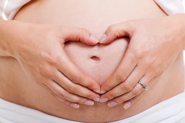 Zwangere vrouw waardoor hart vorm met handen — Stockfoto