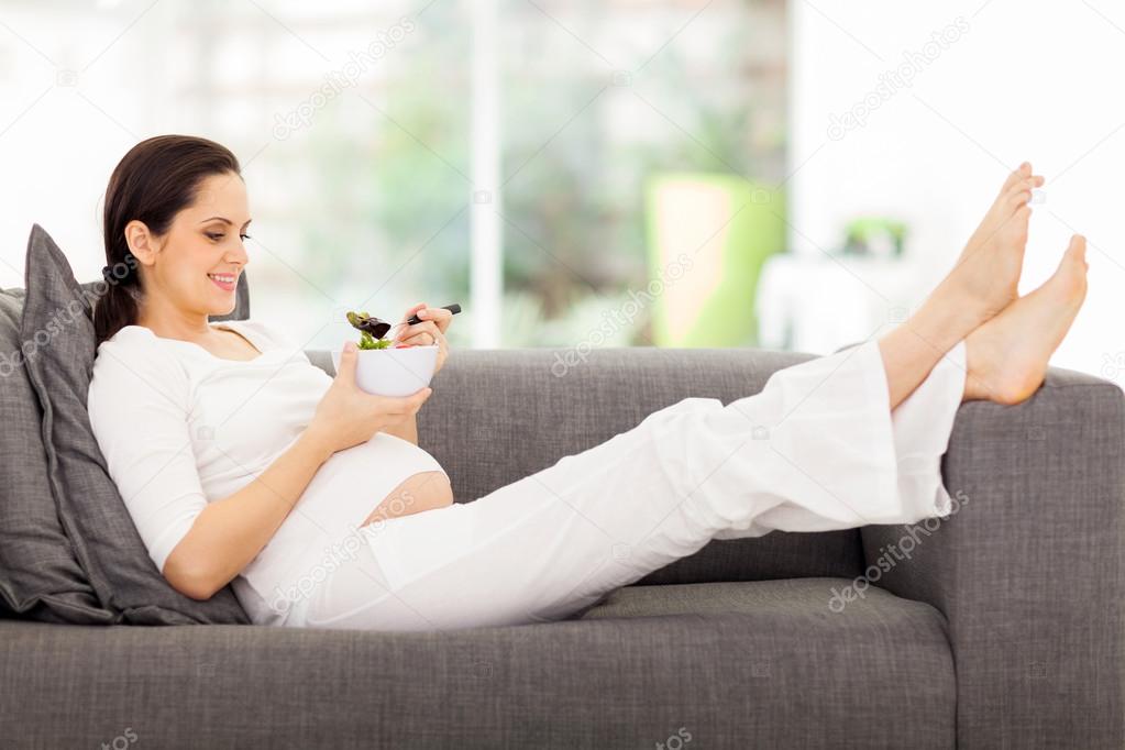 Healthy pregnant woman eating vegetable salad