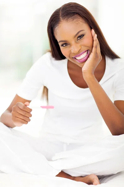 Young african american woman with pregnancy test — Stock Photo, Image