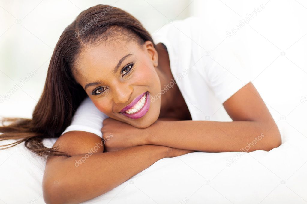 african american woman lying on bed