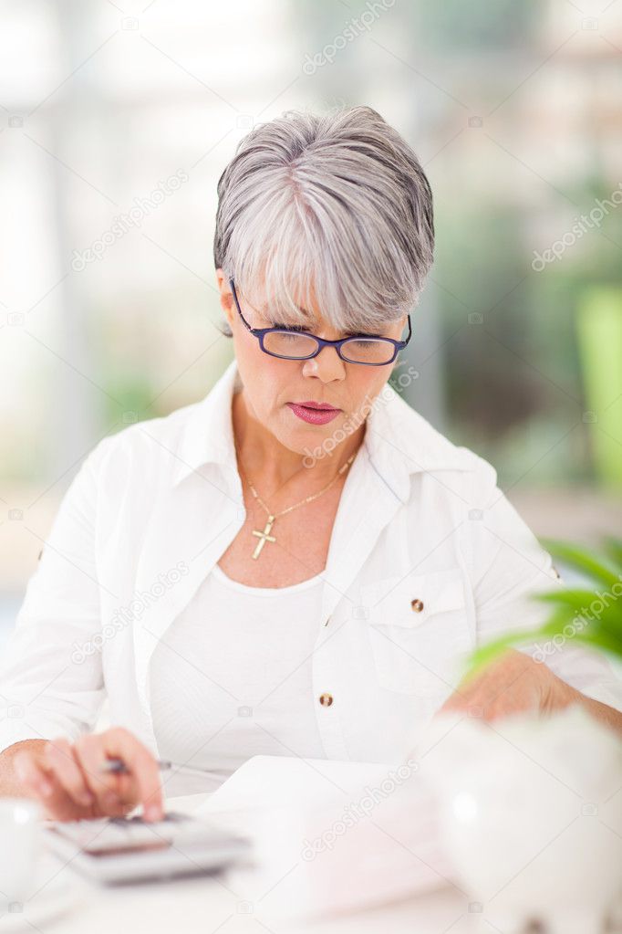 middle aged woman doing her accounts