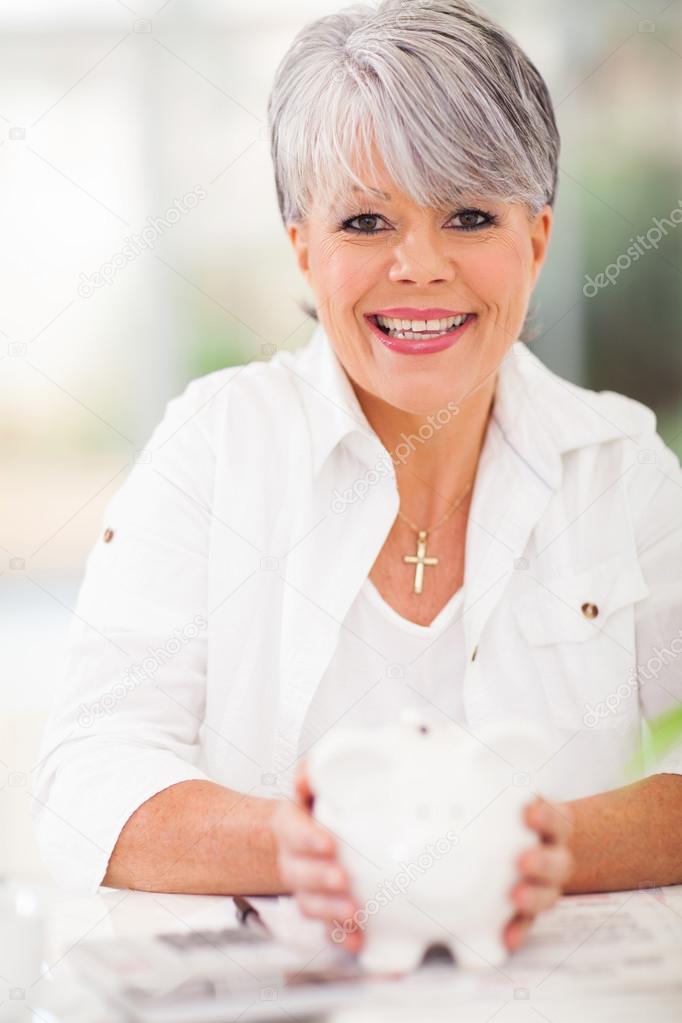 senior woman holding piggybank