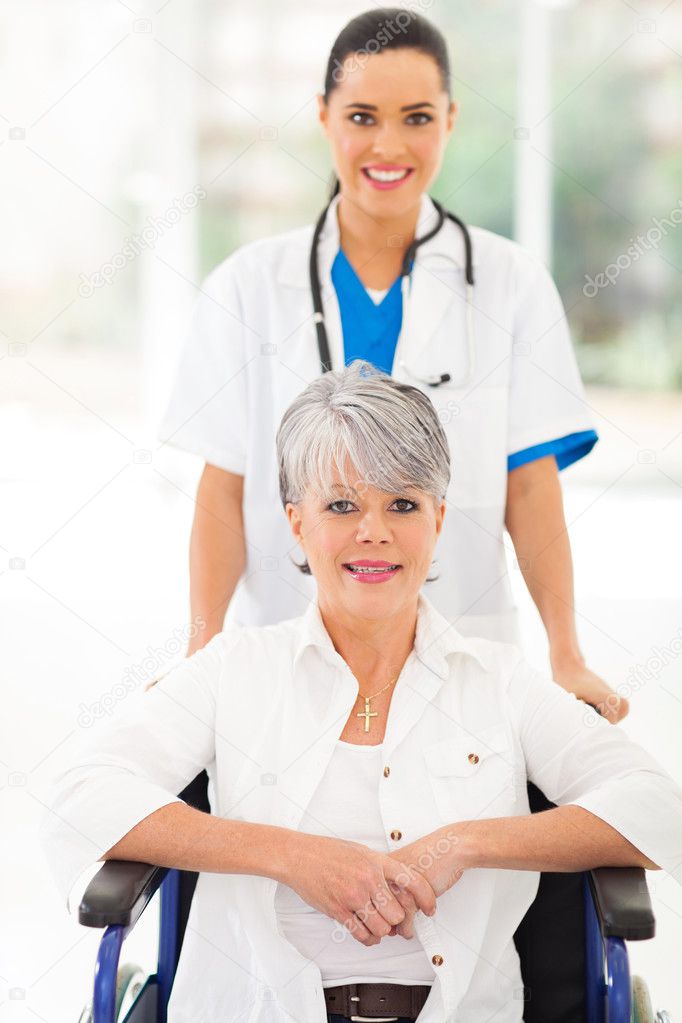 medical nurse taking care of senior patient in wheelchair