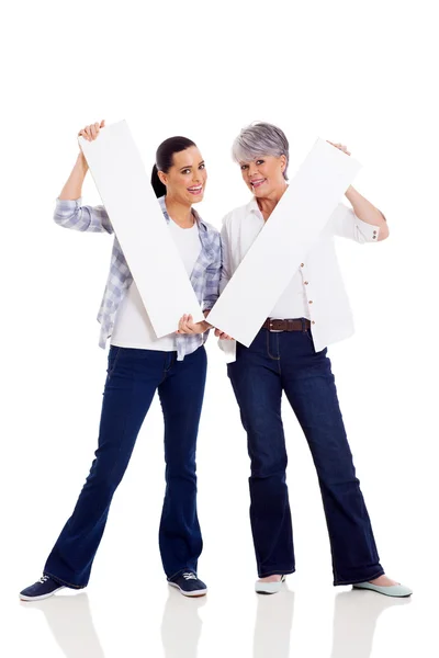 Happy mother and daughter holding white boards — Stock Photo, Image