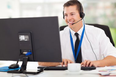 Technical support operator working on computer clipart