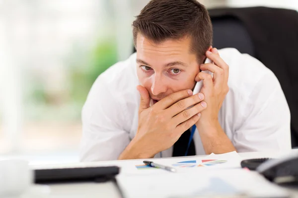 Businessman taking a private call — Stock Photo, Image