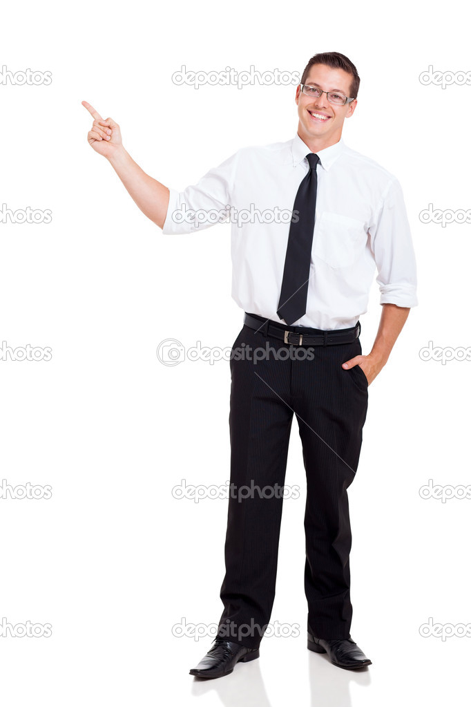 Young businessman pointing at copy space