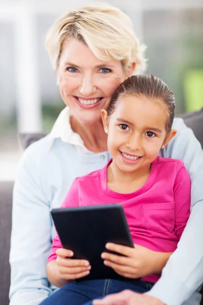 Granddaughter and grandmother with tablet pc — Stock Photo, Image