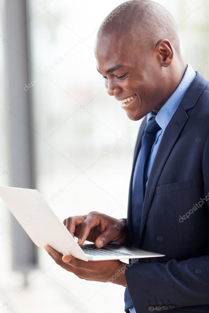 young african american businessman using laptop computer