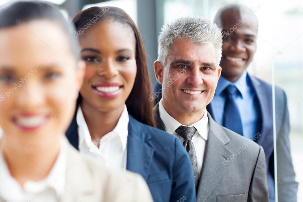 Senior businessman standing in a row