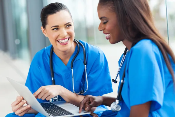 Young female nurses having fun with laptop — Stock Photo, Image