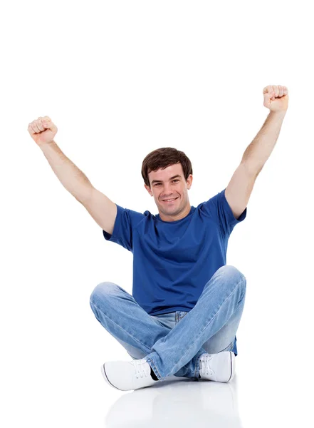 Man sitting on the floor with arms up — Stock Photo, Image