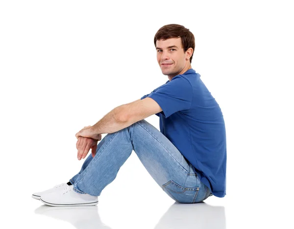 Side view of man sitting on the floor — Stock Photo, Image
