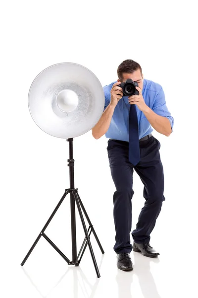 Young photographer working in studio Royalty Free Stock Photos