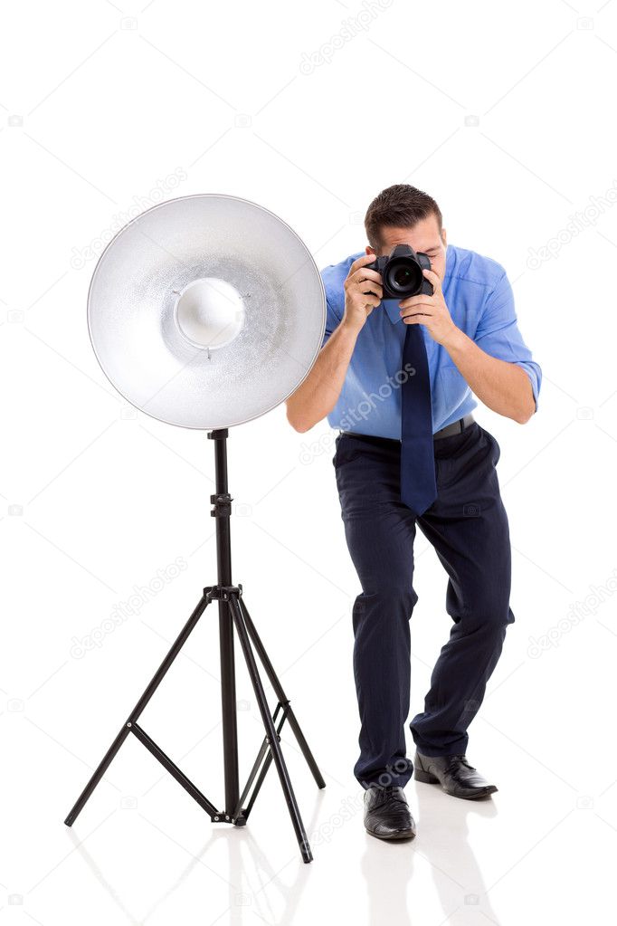 Young photographer working in studio