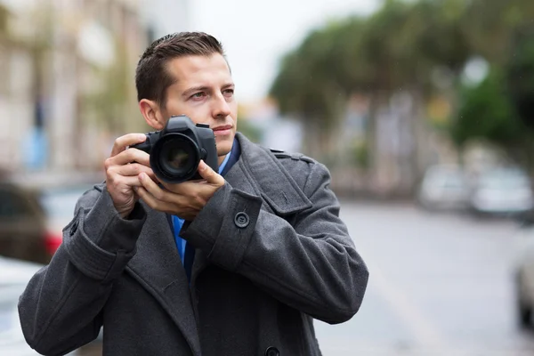 Thoughtful photographer on street — Stock Photo, Image