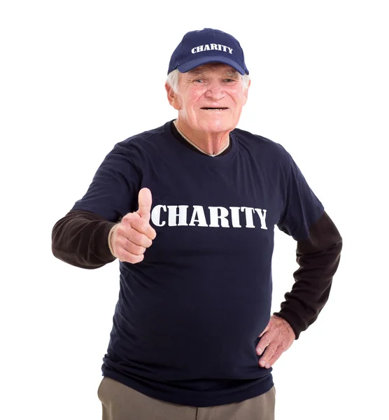 Elderly charity volunteer giving thumb up — Stock Photo, Image