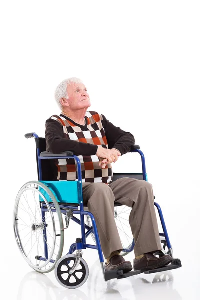 Homme âgé réfléchi sur un fauteuil roulant levant les yeux — Photo