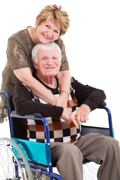 Loving senior wife hugging disabled husband — Stock Photo, Image