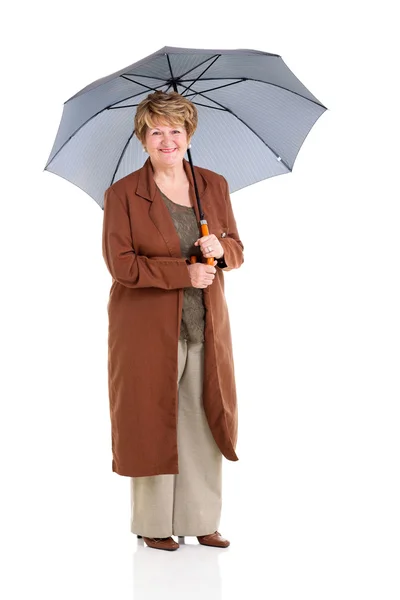 Retired senior woman holding an umbrella — Stock Photo, Image