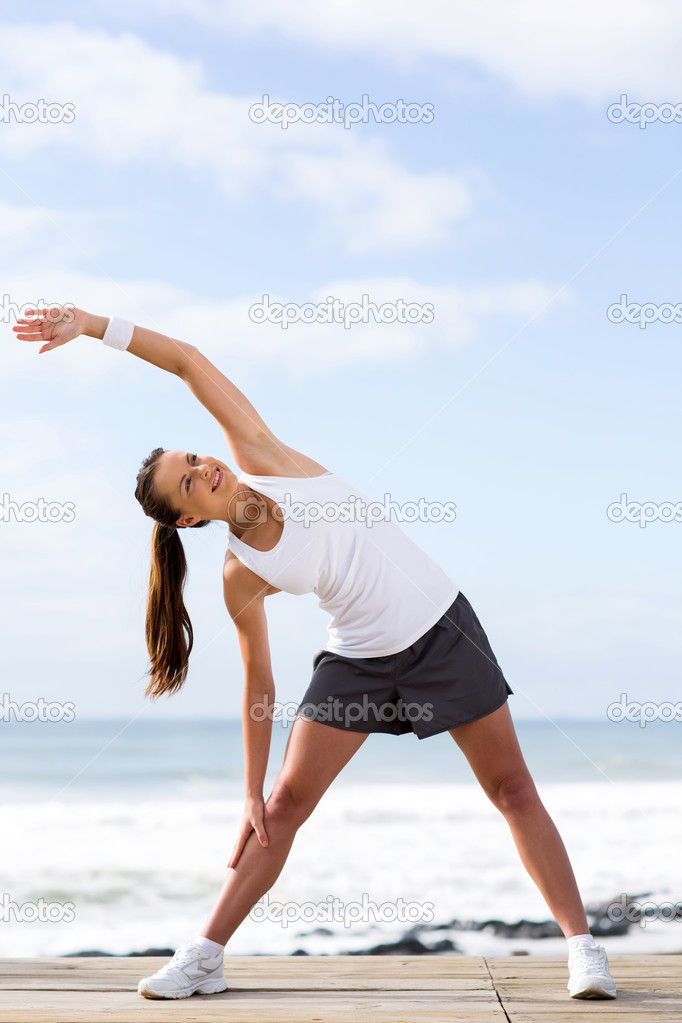 woman stretching at the beach