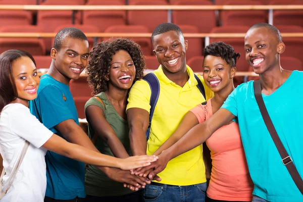 Students putting hands together — Stock Photo, Image