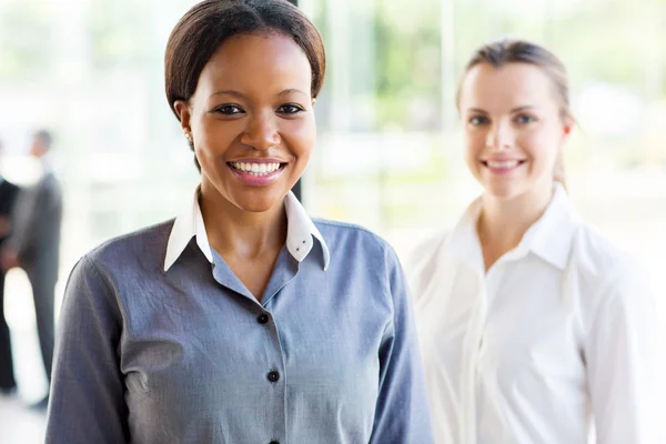 Businesswoman standing in front of colleague — Stock Photo, Image