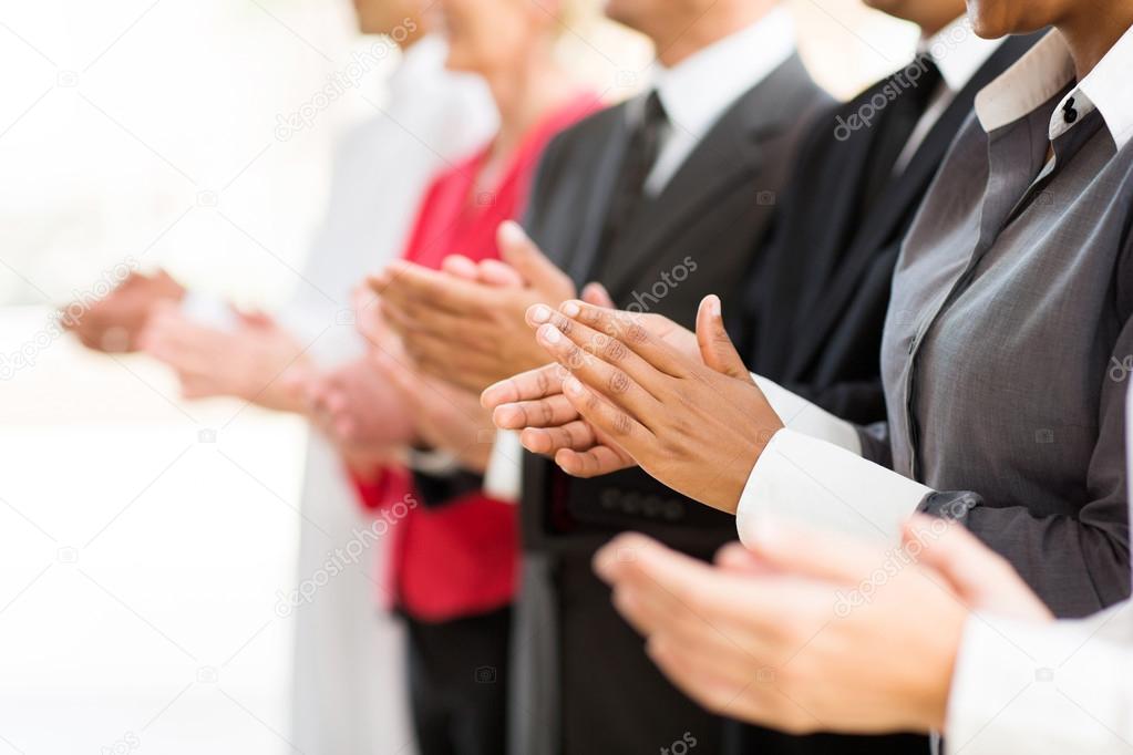 Businesspeople clapping hands