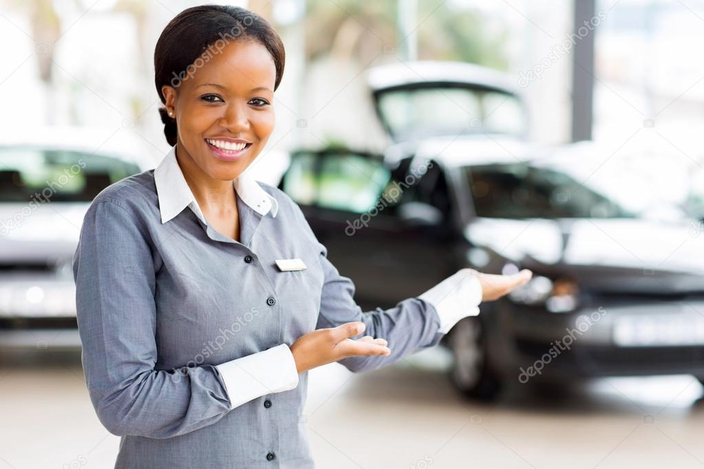 Saleswoman presenting car