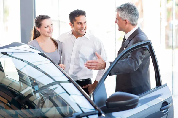 Mature salesman with a couple — Stock Photo, Image