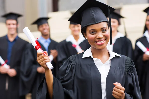 Pretty graduate holding her diploma — Stock Photo, Image