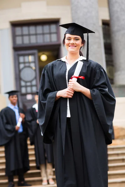 Successful graduate standing near stairs — Stock Photo, Image