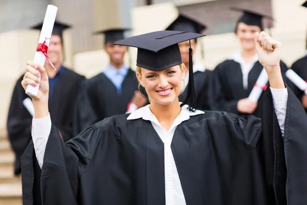 Graduate with outstretched arms holding her certificate Stock Image