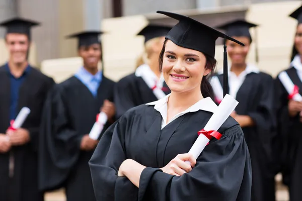 Attractive graduate holding her diploma Royalty Free Stock Images