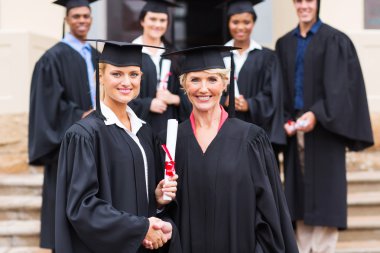 Female graduate handshaking with dean clipart